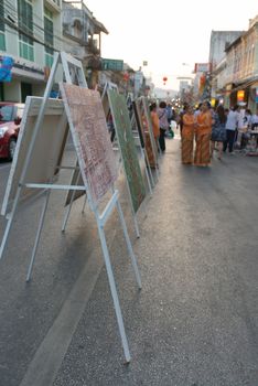 Street art exhibition and people walk on pedestrian street in asian town