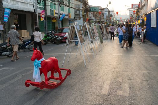 PHUKET, THAILAND - 07 FEB 2014: Art exhibition and unidentified people walk on central pedestrian street during annual old Phuket town festival. 