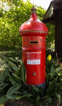 Round english style post office mail or pillar box in garden in Melbourne Australia