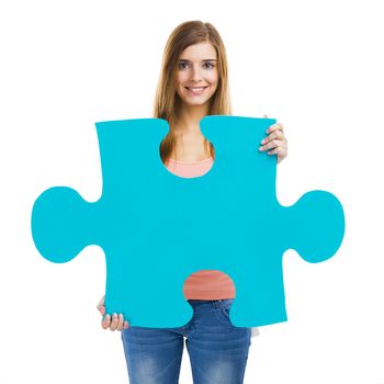Beautiful blonde woman holding a blue piece of puzzle