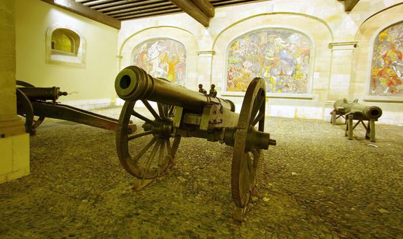 Canons that protects the old city in front of Cingria mosaics at Arsenal courtyard, Geneva, Switzerland