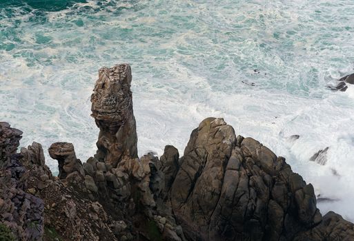 Rocks and Waves with splashes and foam  in the Atlantic Ocean on a stormy day 