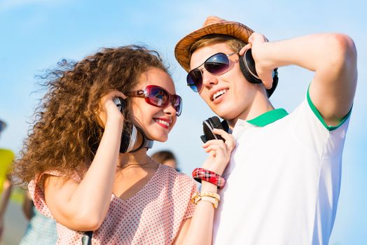 young couple standing on the road, having fun with friends