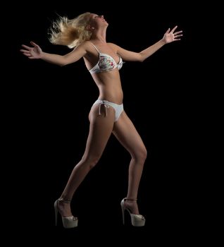 girl in bikini dancing, isolated on black background