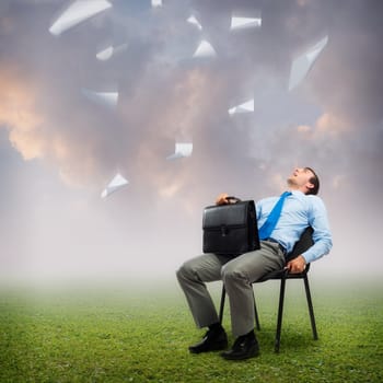 image of a business man looking at the falling paper