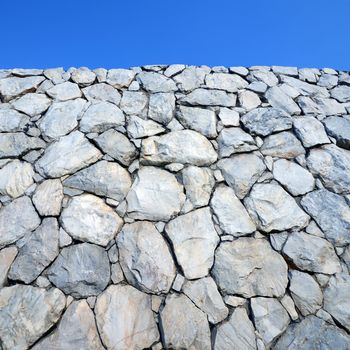 Stone wall background and texture with blue sky 