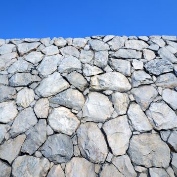 Stone wall background and texture with blue sky 