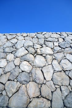 Stone wall background and texture with blue sky 