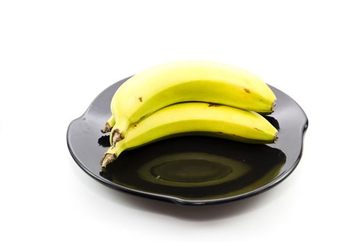 Fresh Yellow Banana on Black Ceramic Plate