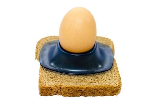Fresh Brown Egg in Egg Cup with Toast Bread