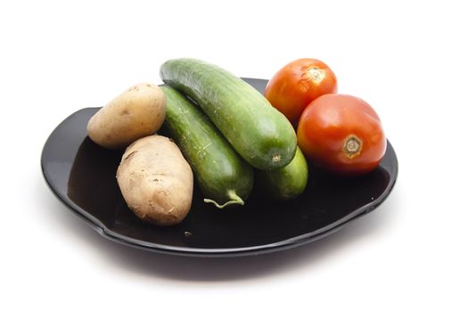 Fresh Cucumber with Red Tomatoes and Potatoes  on ceramic plate