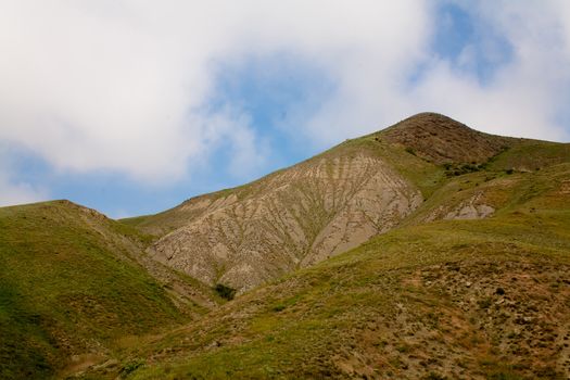 Treeless small mountain with green grass in Crimea
