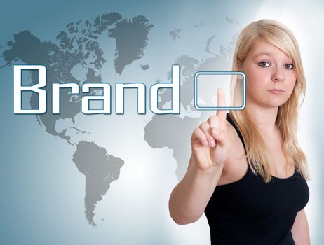 Young woman press digital Brand button on interface in front of her
