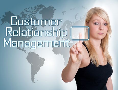 Young woman press digital Customer Relationship Management button on interface in front of her