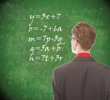 Young student looking at chalkboard with mathematics