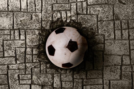a soccer ball destroy a brick wall