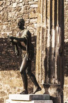 bronze statue inside the pompeii ruins, italy