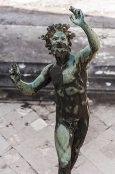 the Fauno bronze statue inside the pompeii ruins, italy