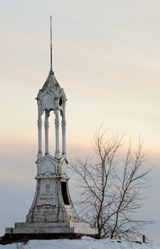 Aged iron beacon in the winter on the Volkhov River. New Ladoga. Russia