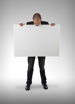 Businessman holding a big card, isolated on white