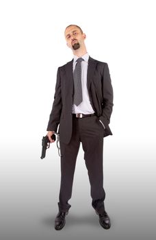 Businessman in handcuffs with pistol in hand, isolated on white