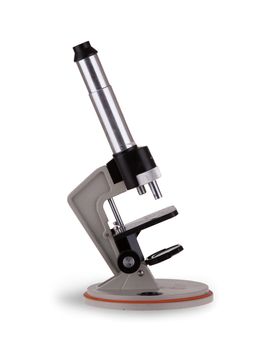 Old microscope isolated on a white background