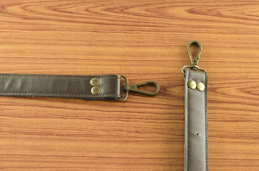 leather strap on wood background