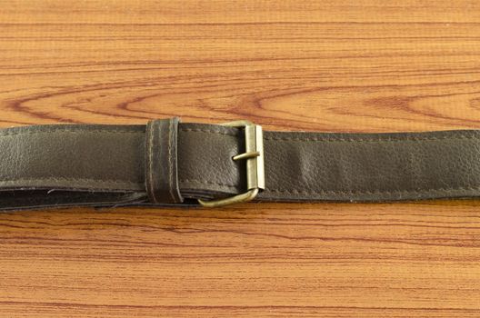 leather strap on wood background