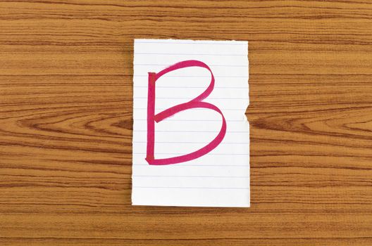 grade b on wood wall background