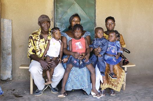 portrait of an African family outside his home in Ouagadougou