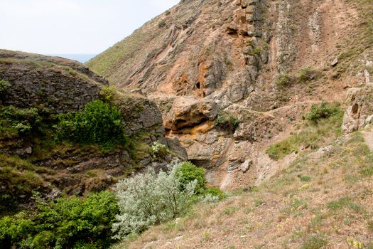 Treeless small mountain with green grass and bush in Crimea
