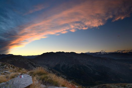 Stunning landscape and romantic cloudscape at sunset in the italian Alps