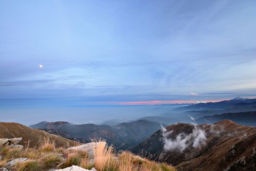 Stunning landscape and romantic cloudscape at sunset in the italian Alps