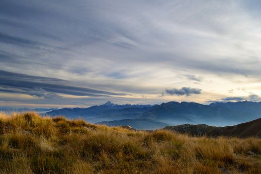 Stunning landscape and romantic cloudscape at sunset in the italian Alps