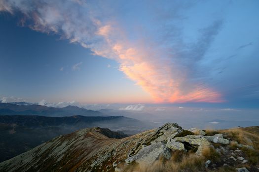 Stunning landscape and romantic cloudscape at sunset in the italian Alps