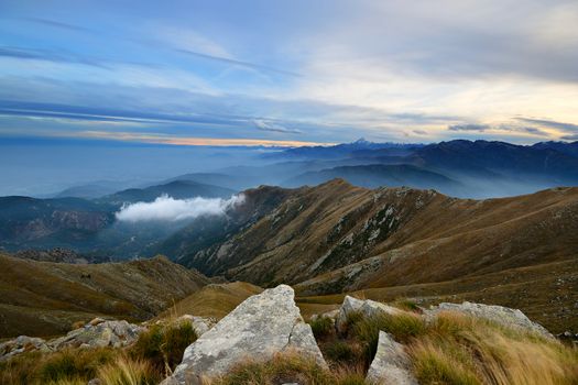 Stunning landscape and romantic cloudscape at sunset in the italian Alps