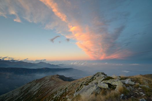 Stunning landscape and romantic cloudscape at sunset in the italian Alps