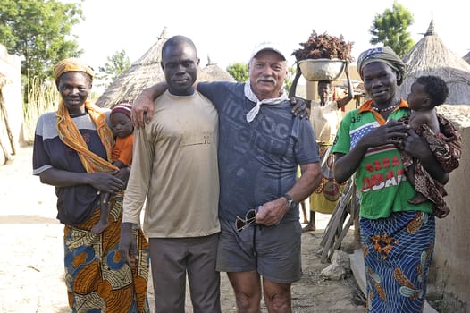 a French tourist makes a visit to a village in Burkina Faso