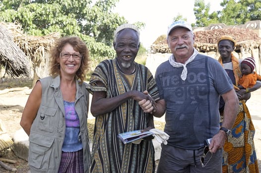 two French tourists makes a visit to a village in Burkina Faso