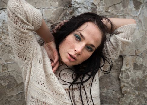 Portrait of a girl against old concrete wall