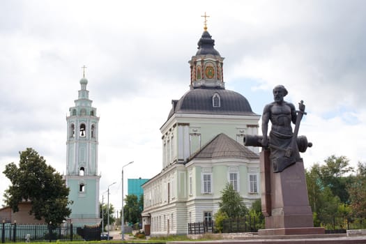 White and green orthodox church and monument
