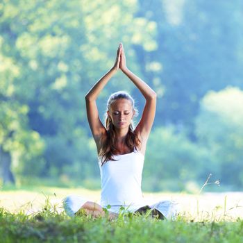 Young woman doing yoga exercise outdoor