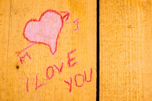 Valentines graffiti on the planks of an old wooden door