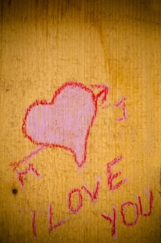 Heart drawn on a grunge wooden background