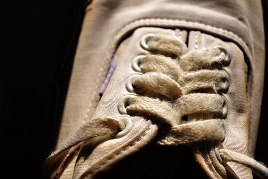 Rope of white sneakers in black background