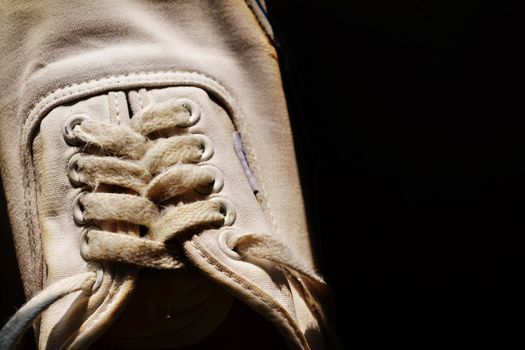 Rope of white sneakers in black background