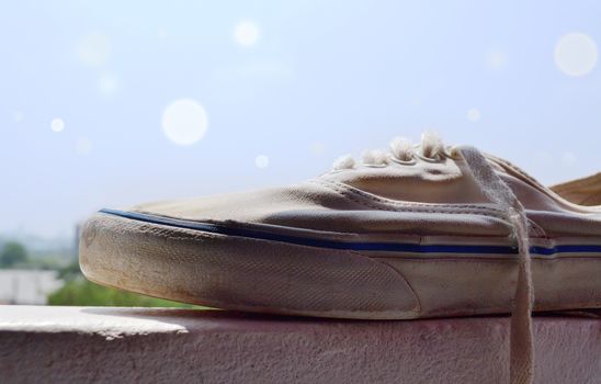 White sneakers placed on the windows in nature