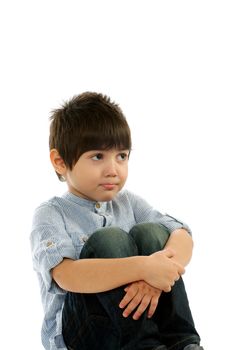 Sad Little Boy in Striped Shirt Biting his Lip Sitting with Hugging his Knees closeup on white background