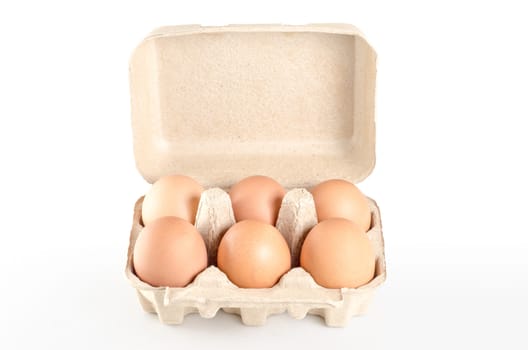 eggs in cardboard tray on white background with clipping path