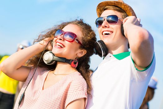 young couple standing on the road, having fun with friends